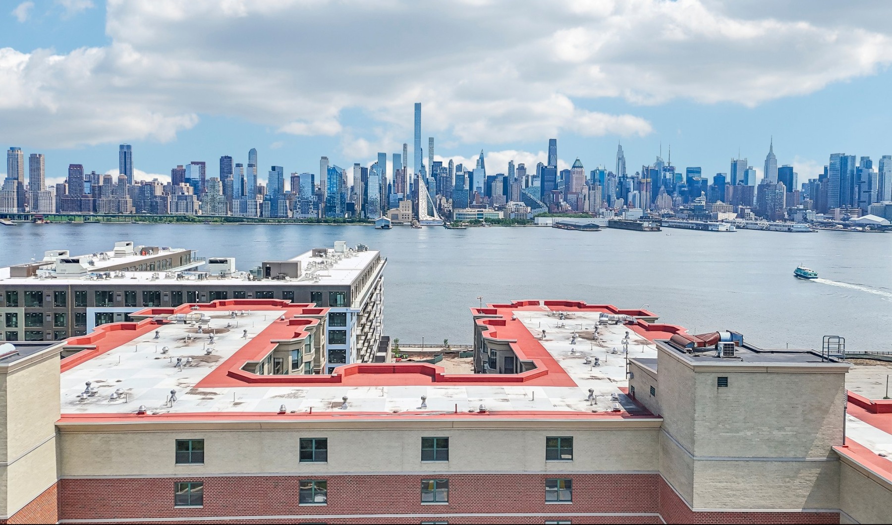 Riverbend building and rooftop with New York City skyline and Hudson River view showing the close proximity.