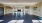 a large empty room with a tv and a few chairs