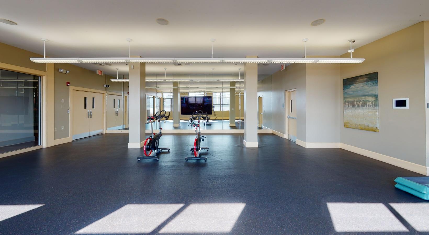 State-of-the-art amenities a large empty room with a tv and a few chairs