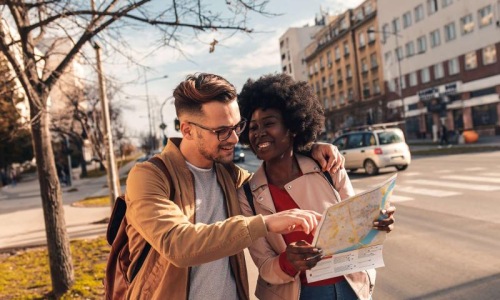 Close to the center of everything a man and woman looking at a map in the city