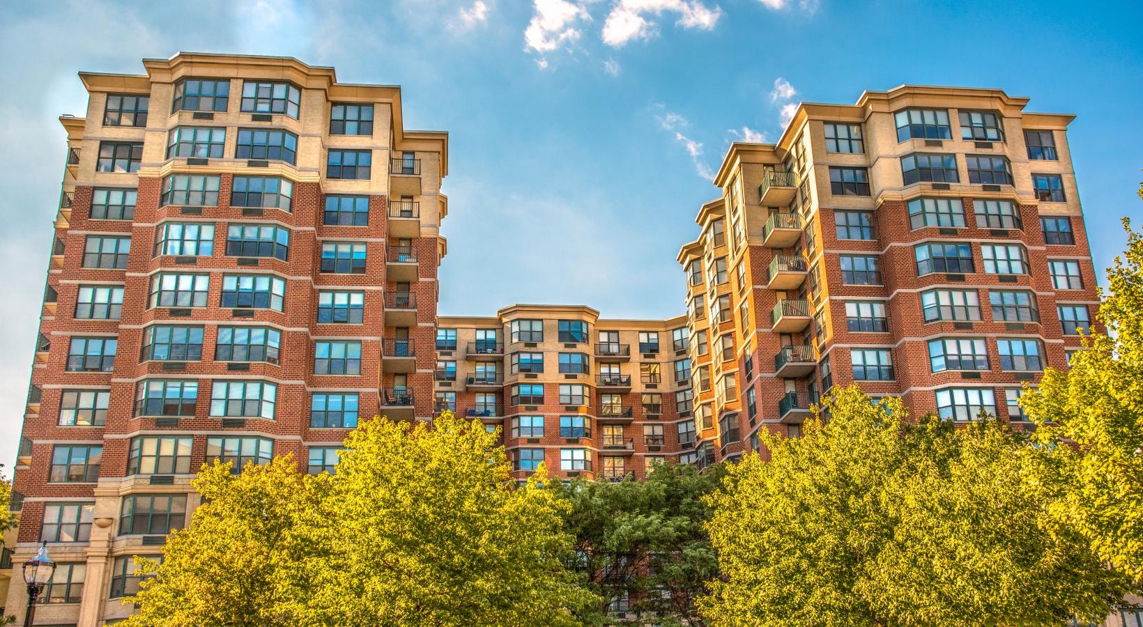 The essence of exceptional living a tall building with trees in front of it