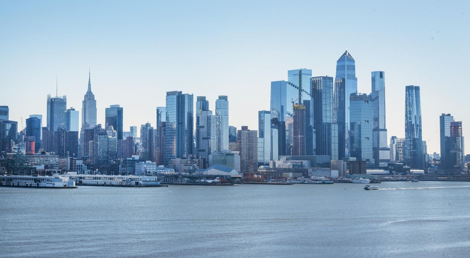 The essence of exceptional living a city skyline with a body of water in the foreground