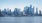 a city skyline with a body of water in the foreground