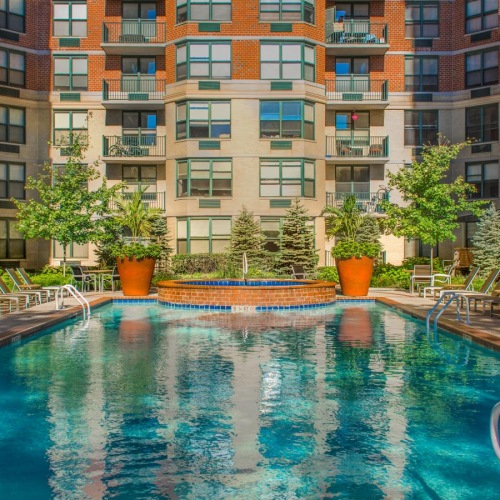 a swimming pool in a courtyard between buildings