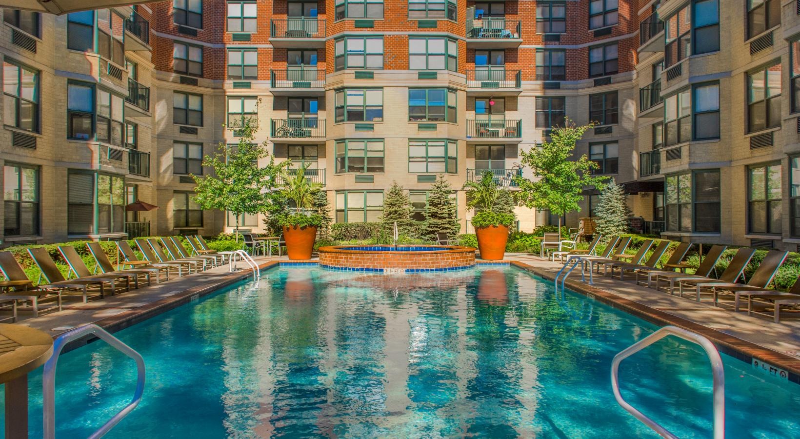 Resort-style swimming pool a swimming pool in a courtyard between buildings