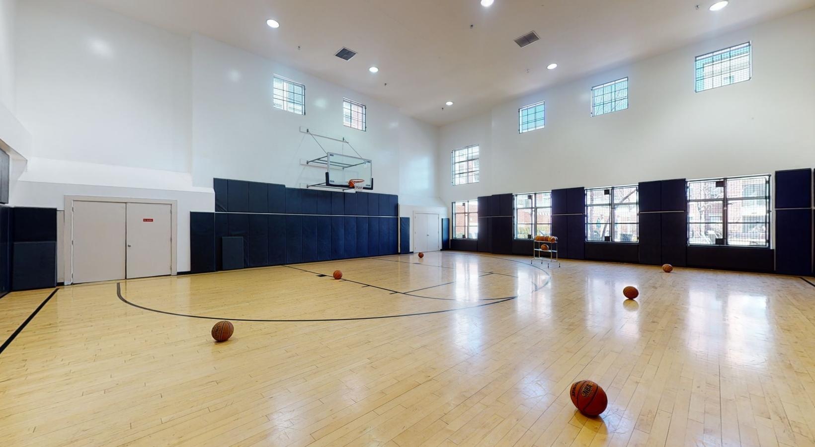 Find your perfect fit at Riverbend at Port Imperial a large empty room with basketballs