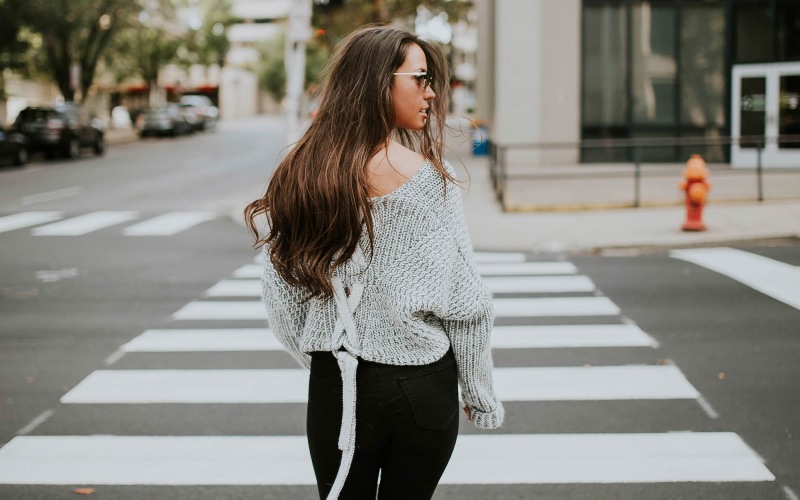 Close to the center of everything a person walking in a crosswalk