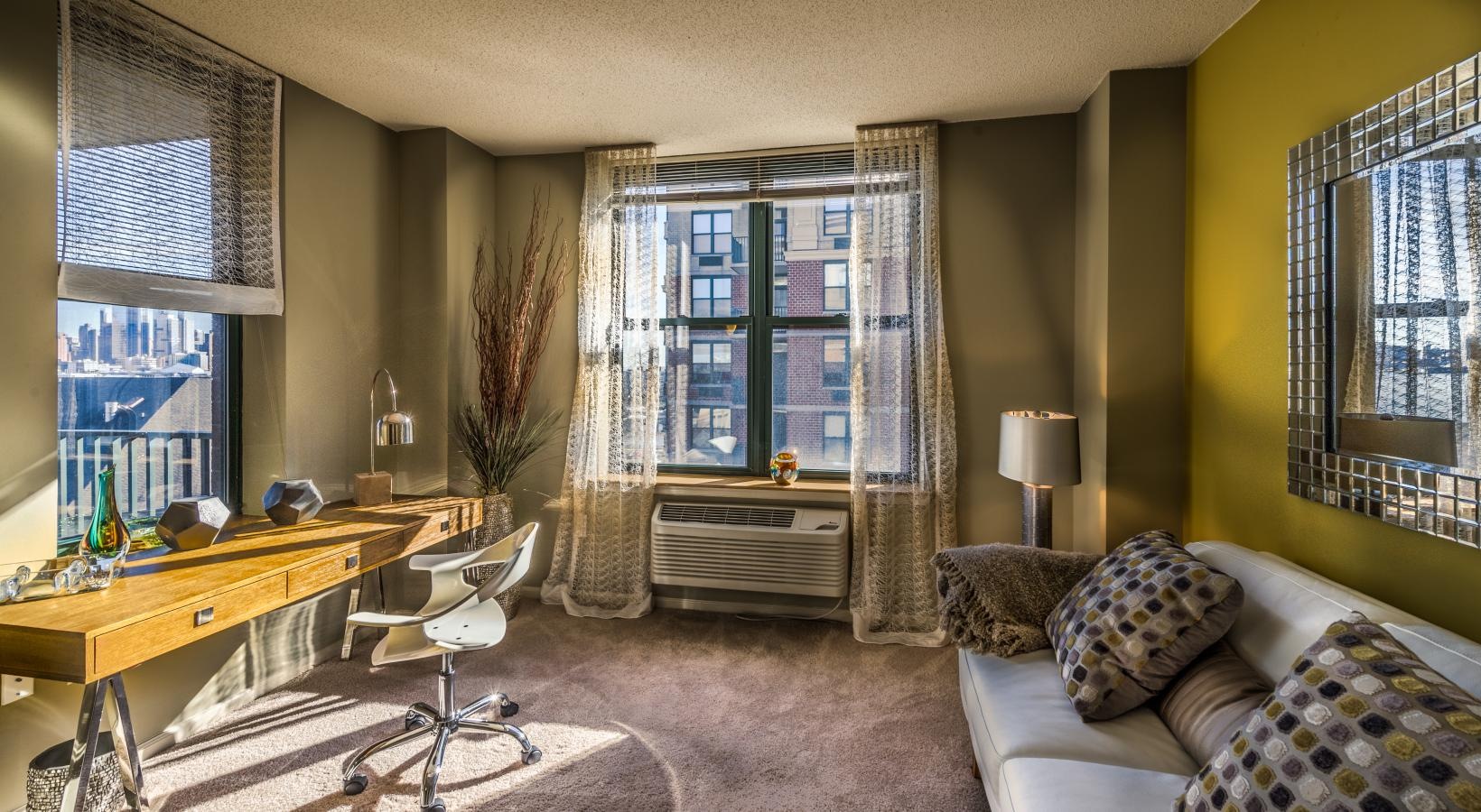 Generous living spaces to relax and unwind a living room with a desk and chair